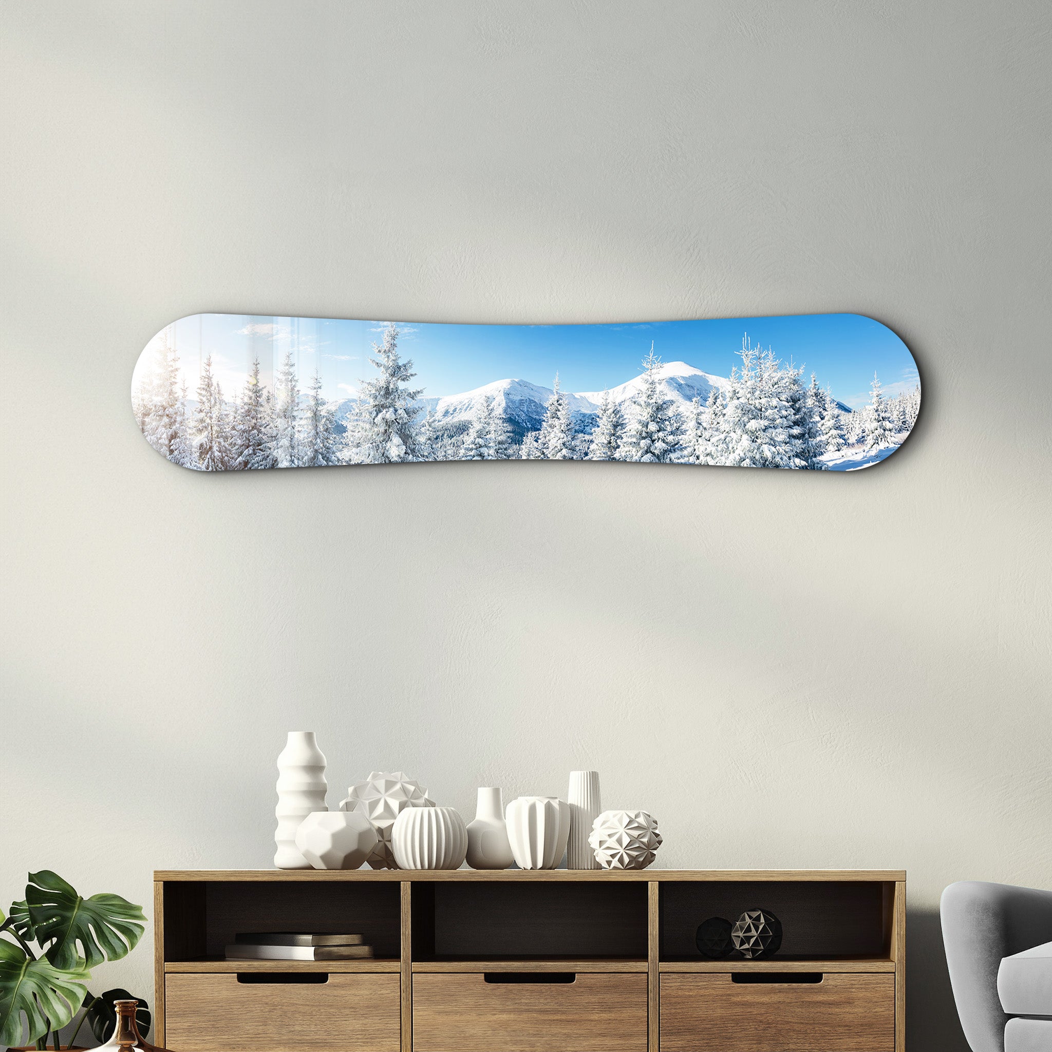 Glass wall art depicting a snowy alpine landscape with mountains and trees, designed by Artdesigna for snowboard-themed decor.