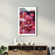 Crimson Garden glass wall art by Artdesigna featuring Yayoi Kusama's vibrant 1984 floral design on clear glass.