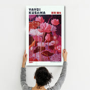 Crimson Garden glass wall art by Yayoi Kusama, featuring vibrant red and floral patterns, displayed on a wall.