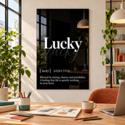 Lucky Definition glass wall art by Artdesigna, black and white typography print in a home office