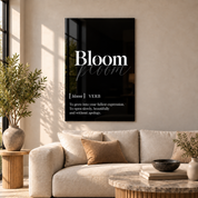 Bloom Definition glass wall art by Artdesigna, black and white typography print in a living room