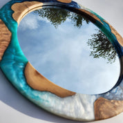 Ocean-inspired epoxy and olive wood wall art mirror, showcasing a unique wooden frame with oceanic epoxy accents.