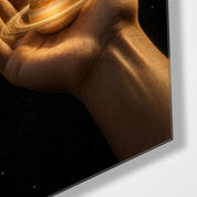 Glass wall art featuring a Saturn in the palm design by Artdesigna, showcasing a sleek, modern glass wall decor piece with celestial details.