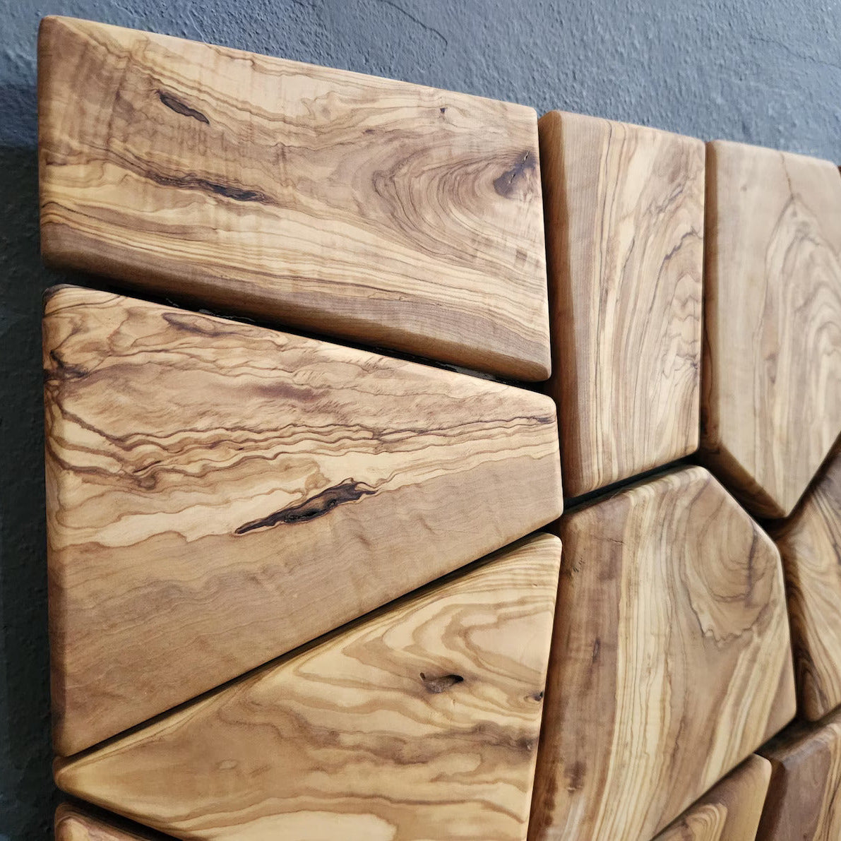 Handmade olive wood geometric wall sculpture by Artdesigna, featuring natural wood tones and intricate geometric design.